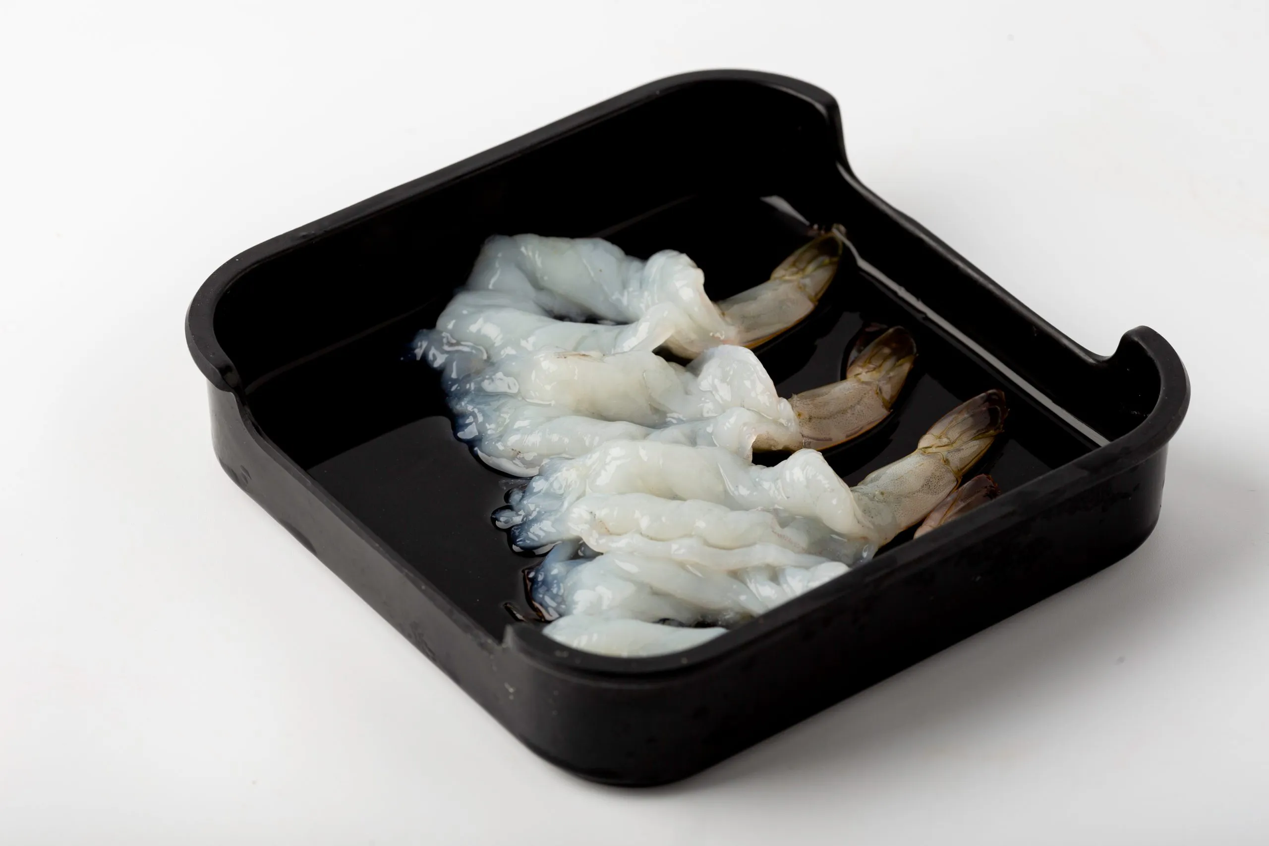 Fresh raw peeled shrimps in a black container at Firestone Hotpot & BBQ Restaurant in Tallahassee